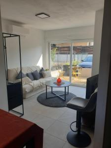 a living room with a couch and a table at Independent studio Varages in Varages