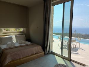 a bedroom with a bed and a view of a patio at Alos Suites in Verga Kalamata