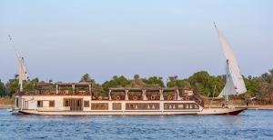 a boat in the water on the water at The Nile Dahabiya Lodge in Luxor +16 photos