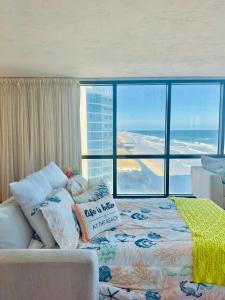 a bedroom with a bed with a view of the ocean at Daytona oceanfront two-bedroom suite in Daytona Beach
