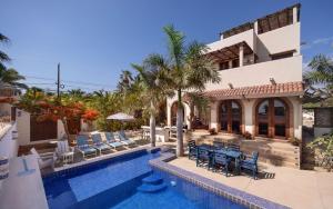 a villa with a swimming pool and a house at Casa Perla de Todos Santos in Todos Santos