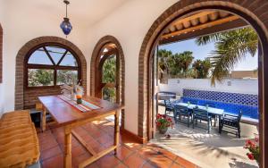 a patio with a table and chairs and a pool at Casa Perla de Todos Santos in Todos Santos