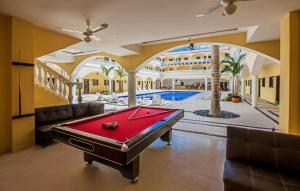 a pool room with a pool table in a house at We playa Hotel-Hostel in Playa del Carmen