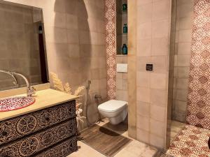 a bathroom with a toilet and a sink at Riad Darabi l Private Medina Home in Marrakesh +23 photos