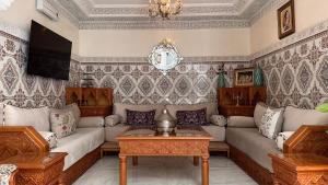 a living room with a couch and a table at Riad Darabi l Private Medina Home in Marrakesh