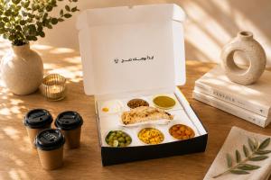 a box of breakfast food on a table at Lake View By Bait Zain in As Sīfah