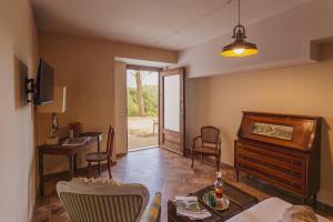 a living room with a piano and a table and chairs at Tenuta di Monte Gemini in Campagnano di Roma