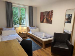 a living room with a couch and a chair at Basement Rotherbaum in Hamburg