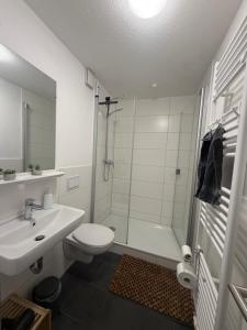 a bathroom with a sink and a toilet and a shower at Basement Rotherbaum in Hamburg +6 photos