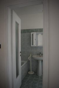 a bathroom with a sink and a tub and a toilet at Appartamento Rubiana in Rubiana +24 photos