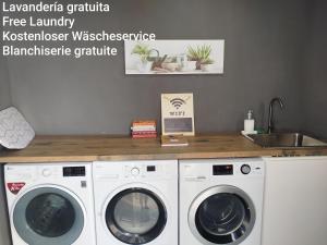 a kitchen with two washing machines and a counter at La de Simón in A Guarda