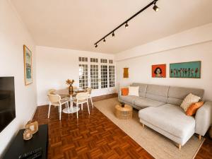 a living room with a couch and a table at Ponte Velha in Peniche