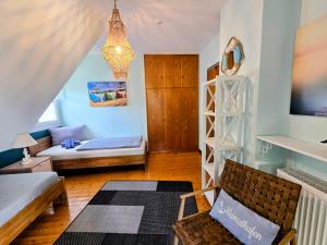 a living room with a bed and a couch at HR Townhouse Honigbach in Coesfeld