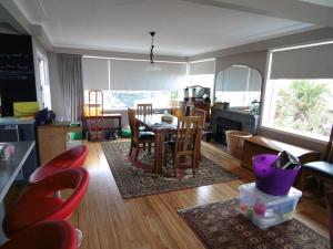 a living room with a table and chairs at Rosemount B&B by the Sea St Clair in Dunedin