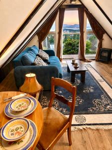 a living room with a couch and a table at Fjord Panorama Lodge in Strand