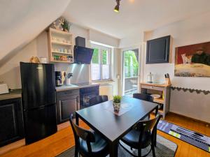 a kitchen and dining room with a table and chairs at HR Townhouse Honigbach in Coesfeld
