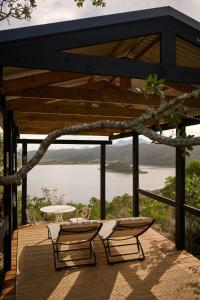 a patio with a table and chairs and a view of a lake at Wish You Were Here! in Wilderness