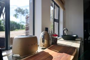 a kitchen counter with a toaster on a cutting board at Wish You Were Here! in Wilderness