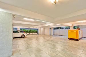 a large garage with a car parked in it at Hotel Cachet in Coimbatore