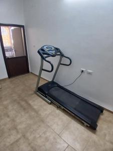 a treadmill is against a wall in a room at Art & View Family Jacuzzi Suite with Balcony in Maghār +11 photos