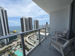 a balcony with a chair and a view of the city at Steps from the Beach - Amazing Views in Hollywood