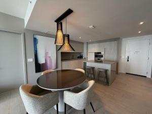 a kitchen and dining room with a table and chairs at Steps from the Beach - Amazing Views in Hollywood