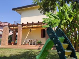 a green slide in front of a house at Wilma House in Mestre +30 photos