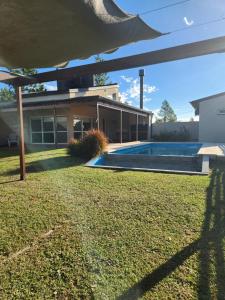 a house with a swimming pool in the yard at Alborada in Gualeguaychú