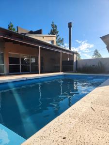 a swimming pool in front of a house at Alborada in Gualeguaychú