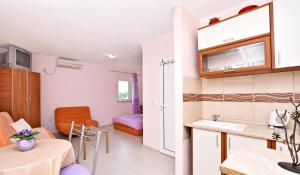 a small room with a kitchen and a living room at Vila Mia in Donji Štoj
