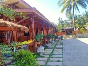a building with potted plants in front of it at Awang Homestay in Bumbang