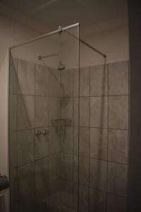 a shower with a glass door in a bathroom at Eagle Waters in Vanderkloof +36 photos