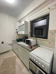 a kitchen with a counter top with a microwave at Solid House Apartment - Sea View in Mamaia