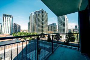 a balcony with a view of a city with tall buildings at BW Cityline Residences in Belgrade