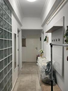 a hallway with glass panels on the wall at Solid House Apartment - Sea View in Mamaia