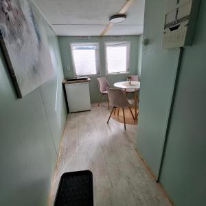 a small room with a table and chairs in it at casabandow in Schwaan