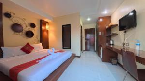 a bedroom with a large bed and a flat screen tv at Azure Stays Patong in Patong Beach