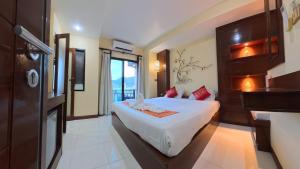 a hotel room with a bed and a tv at Azure Stays Patong in Patong Beach