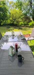 a table with a cup and a plate of food on it at Willa Baśka in Chańcza