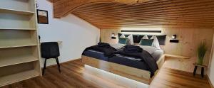 a bedroom with a bed with a wooden ceiling at Apartment Wegmo in Bischofshofen