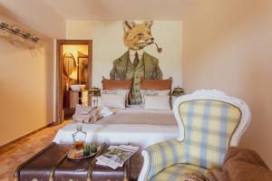 a bedroom with a bed with a painting of a fox on the wall at Tenuta di Monte Gemini in Campagnano di Roma