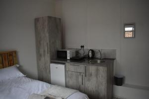 a small kitchen with a sink and a microwave at Eagle Waters in Vanderkloof
