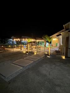 a parking lot with trees and lights at night at Yumigahama Eaglehouse 2 in Minamiizu