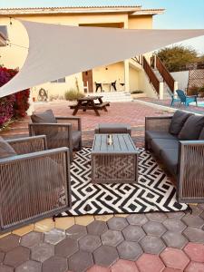 a patio with chairs and a table and a white canopy at sol appartement 3 in Willemstad
