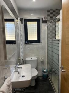 a bathroom with a sink and a toilet and a window at Peregrino in Pontevedra