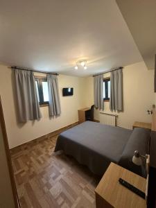 a bedroom with a bed and a table and windows at Peregrino in Pontevedra +36 photos