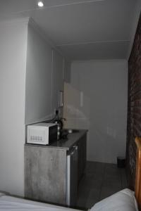 a small kitchen with a microwave on a counter at Eagle Waters in Vanderkloof