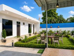 a patio of a house with a table and chairs at Omkara Villa Sonipat in Sonīpat
