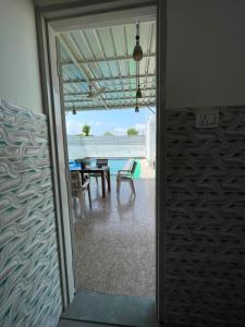 a sliding glass door leading to a patio with a table at Omkara Villa Sonipat in Sonīpat
