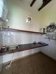 a kitchen with a sink and a counter at Omkara Villa Sonipat in Sonīpat +35 photos